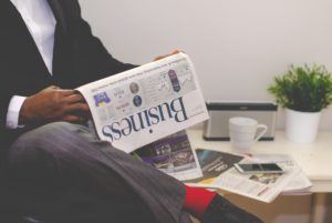 Effective morning habits man reading newspaper